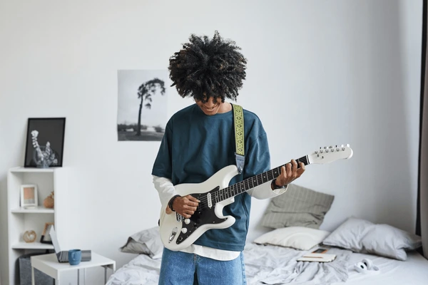 A confident student playing guitar
